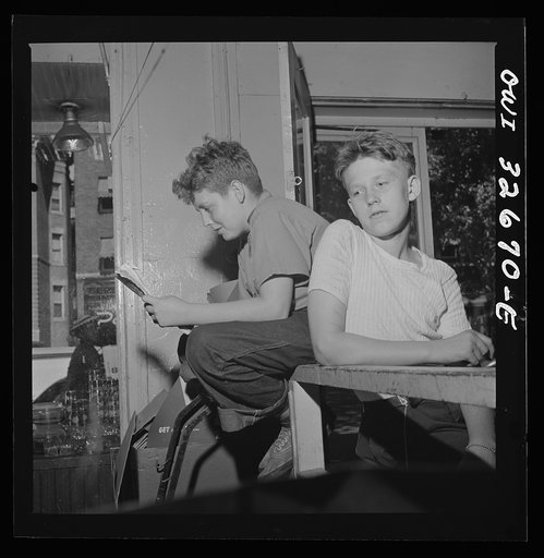 Washington, D.C. Two boys waiting to help customers with their orders at a grocery store