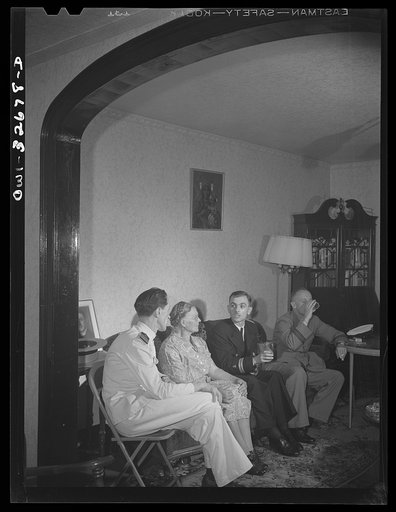 Oswego, New York. Canadian flight commander and Polish naval officers visiting in the home of a Polish-American family