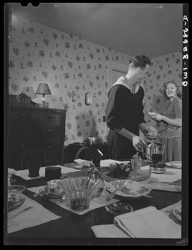 Oswego, New York. Norwegian sailor helping his hostess's daughter to clear the breakfast table during United Nations week