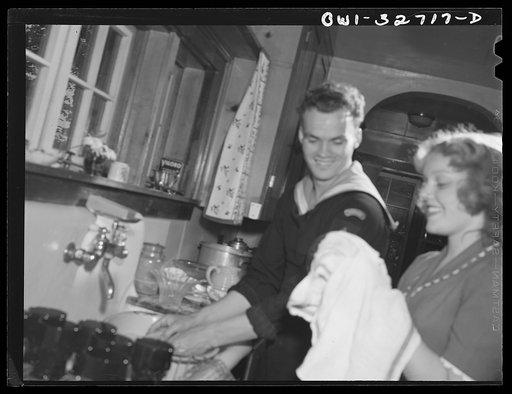Untitled photo, possibly related to: Oswego, New York. Norwegian sailor helping his hostess's daughter to clear the breakfast table during United Nations week