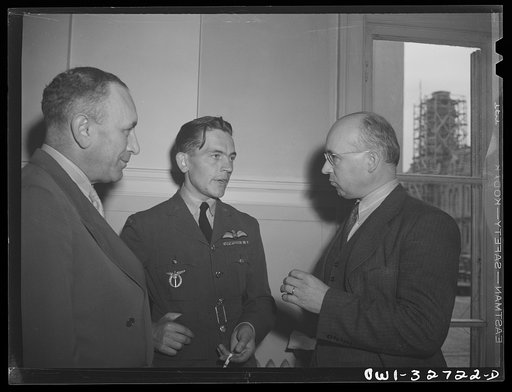 Oswego, New York. A Czechoslovakian flier in the Royal Air Force chats with the Czech consul and a Rotarian at the Rotary Club luncheon during United Nations week