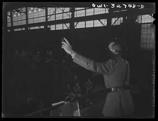Untitled photo, possibly related to: Oswego, New York. Dutch Army officer and a British naval officer, accompanied by the plant's general manager, chatting with a welder in the Fitzgibbons tank factory during United Nations week