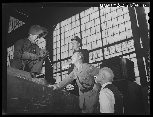 Oswego, New York. Dutch Army officer and a British naval officer, accompanied by the plant's general manager, chatting with a welder in the Fitzgibbons tank factory during United Nations week