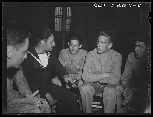 Untitled photo, possibly related to: Oswego, New York. A Norwegian sailor talking informally with air cadets who are entertaining United Nations heroes at a supper during United nations week