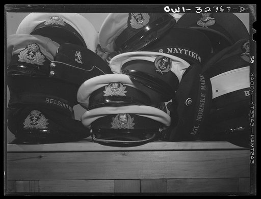 Untitled photo, possibly related to: Oswego, New York. United Nations heroes' hats stacked while they eat supper served by the women of the Presbyterian church