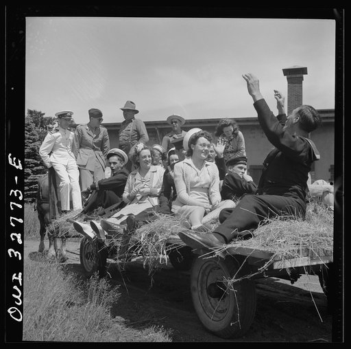 Oswego, New York. Belgian sailor leads singing on a hayride for the United Nations heroes and Oswego girls during United Nations week
