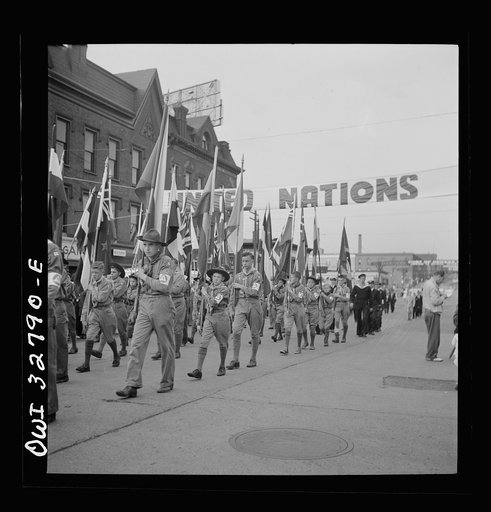 Untitled photo, possibly related to: Oswego, New York. United Nations heroes marching behind the boy scouts carrying flags in the United Nations week parade