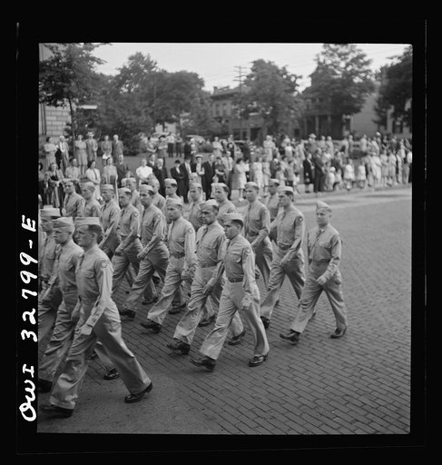 Untitled photo, possibly related to: Oswego, New York. United Nations heroes marching behind the boy scouts carrying flags in the United Nations week parade