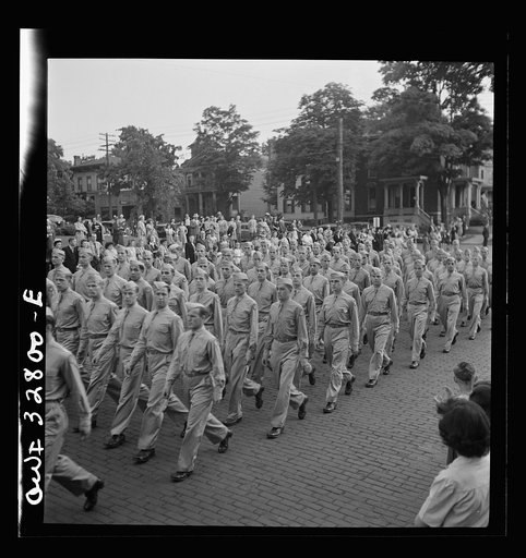 Untitled photo, possibly related to: Oswego, New York. United Nations heroes marching behind the boy scouts carrying flags in the United Nations week parade