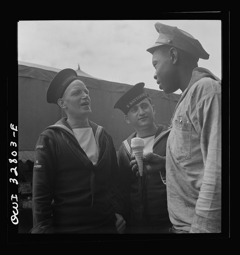 Oswego, New York. Belgian and Greek sailors talking with a Negro worker at the carnival during United Nations week
