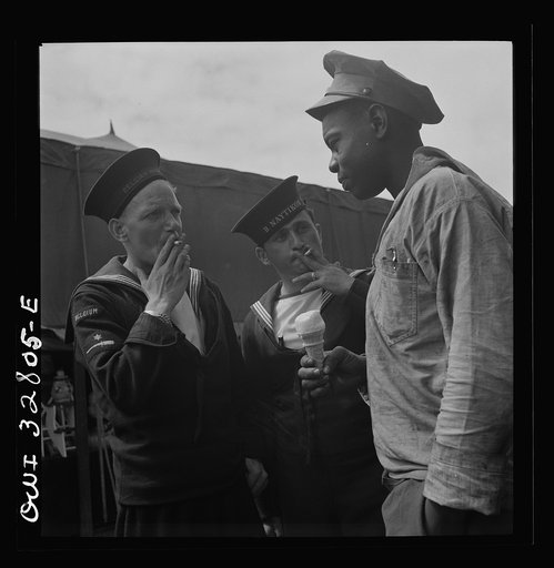 Untitled photo, possibly related to: Oswego, New York. Belgian and Greek sailors talking with a Negro worker at the carnival during United Nations week