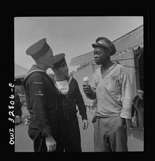 Oswego, New York. Belgian and Greek sailors talking with a Negro worker at the carnival during United Nations week