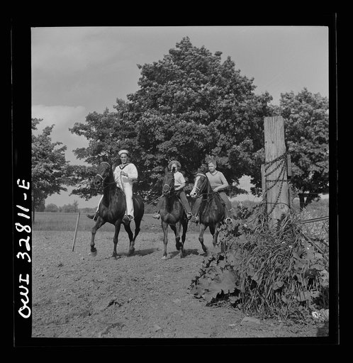 Oswego, New York. Belgian sailor riding a horse with the farmer's son and daughter on the farm visited by the United Nations heroes during United Nations week