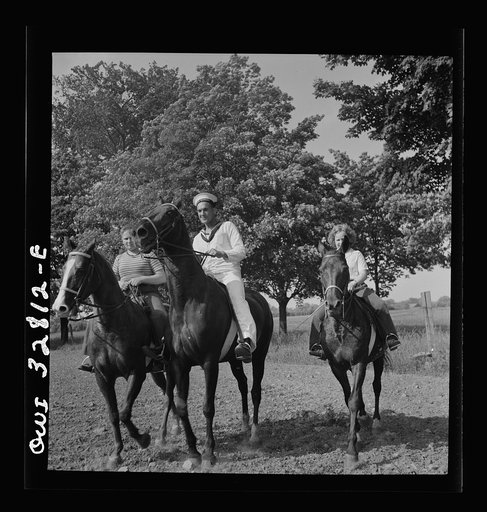 Untitled photo, possibly related to: Oswego, New York. Belgian sailor riding a horse with the farmer's son and daughter on the farm visited by the United Nations heroes during United Nations week