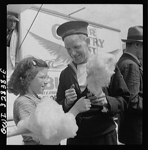 Oswego, New York. A Belgian sailor giving sponge sugar to a little girl at the carnival during United Nations week