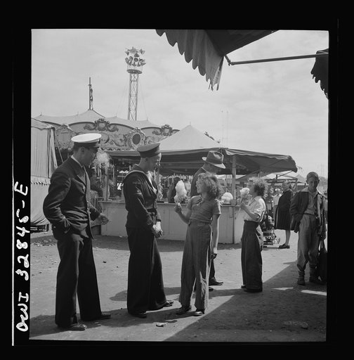 Untitled photo, possibly related to: Oswego, New York. A Belgian sailor giving sponge sugar to a little girl at the carnival during United Nations week