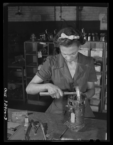 Philadelphia, Pennsylvania. Miss Beatrice Paul, mother of two children, working on a generator at the garage of the Yellow Cab Company. Her husband also works for the cab company, in the tire department