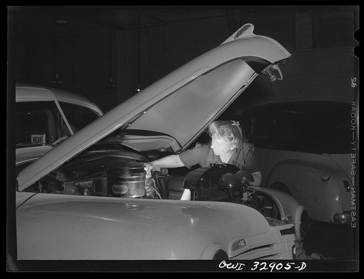 Philadelphia, Pennsylvania. Miss Lillie Malcolm, a garage mechanic for the Yellow Cab Company. She is installing an oil clarifier cartridge