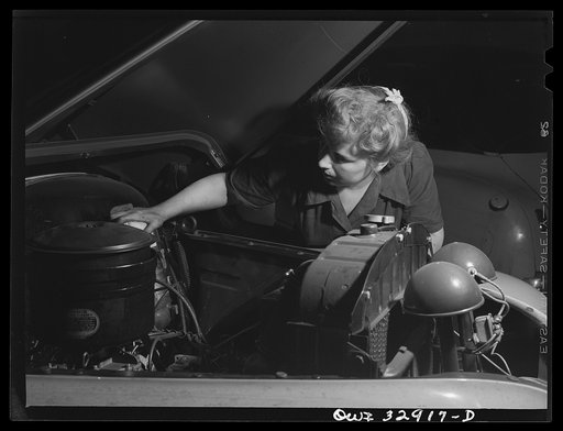 Philadelphia, Pennsylvania. Miss Lillie Malcolm, a garage mechanic for the Yellow Cab Company. She is installing an oil clarifier cartridge