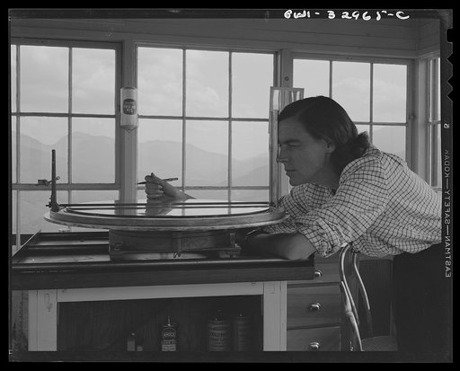Untitled photo, possibly related to: Gorham (vicinity), New Hampshire. Barbara Mortensen, a fire and airplane lookout on Pine Mountain, sighting suspicious smoke through a fire finder so as to locate accurately its source by cross bearings on the topographical chart