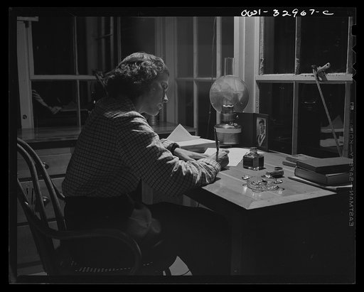 Gorham (vicinity), New Hampshire. Evenings are long and lonely for Barbara Mortensen, a fire and airplane lookout on Pine Mountain. She reads or writes letters to her husband who is in the U.S. Navy