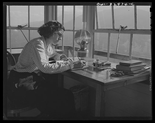 Gorham (vicinity), New Hampshire. Barbara Mortensen, a fire and airplane lookout on Pine Mountain, keeping her reports up to date