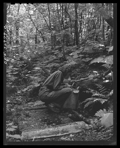 Gorham (vicinity), New Hampshire. Barbara Mortensen, a fire and airplane lookout on Pine Mountain, filling her metal pack to carry back up one half mile of trail to the fire tower