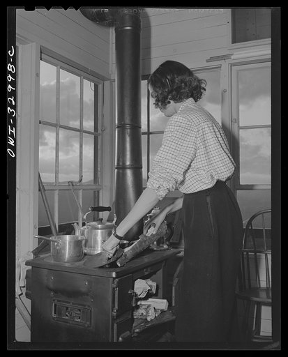 Gorham (vicinity), New Hampshire. Barbara Mortensen, a fire and airplane lookout on Pine Mountain does all her cooking in the tower. Wood and water must be carried up fifty-six steps from the mountain top below