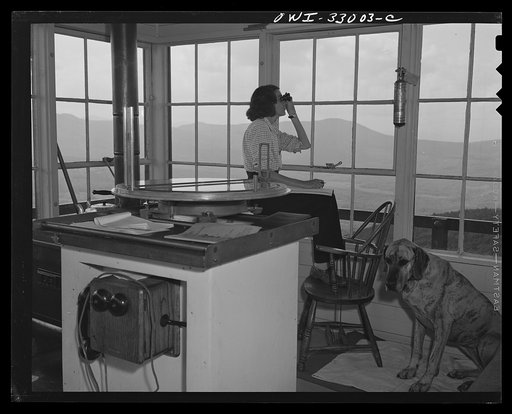 Gorham (vicinity), New Hampshire. Barbara Mortensen, along with her fire lookout duties on Pine Mountain, also spots planes for the Interceptor Command