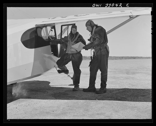 Bar Harbor Maine. Civil Air Patrol base headquarters of coastal patrol no. 20. A pilot and an observer, clad in all-rubber, watertight crash suits, ready for flight