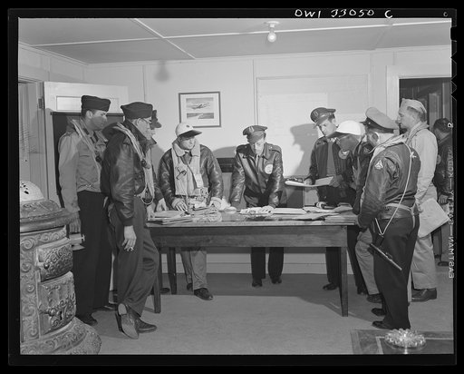 Bar Harbor, Maine. Civil Air Patrol base headquarters of coastal patrol no. 20. Flyers getting their orders from the intelligence officer before taking off on dawn patrol