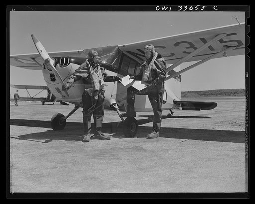 Bar Harbor, Maine. Civil Air Patrol base headquartes of coastal patrol no. 20. The pilot and an observer, clad in all-rubber, watertight crash suits, ready for flight