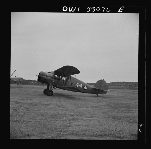 Untitled photo, possibly related to: Bar Harbor, Maine. Civil Air Patrol base headquartes of coastal patrol no. 20. Ground crew mechanics overhauling a tail assembly during routine check-over