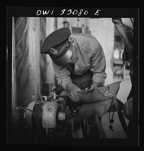 Bar Harbor, Maine. Civil Air Patrol base headquarters of coastal patrol no. 20. Blowing up "Mae West" life preservers by compressed air for a routine check of safety equipment