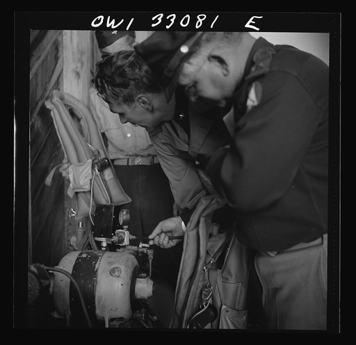 Untitled photo, possibly related to: Bar Harbor, Maine. Civil Air Patrol base headquarters of coastal patrol no. 20. Blowing up "Mae West" life preservers by compressed air for a routine check of safety equipment