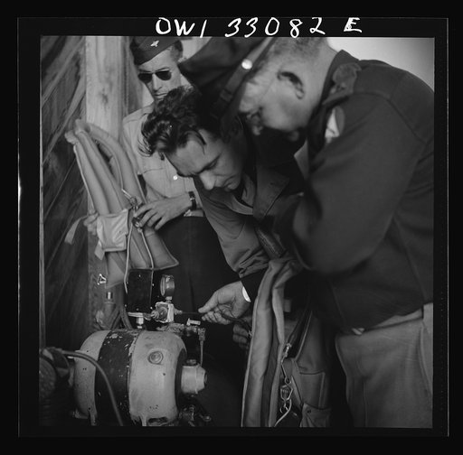 Untitled photo, possibly related to: Bar Harbor, Maine. Civil Air Patrol base headquarters of coastal patrol no. 20. Blowing up "Mae West" life preservers by compressed air for a routine check of safety equipment