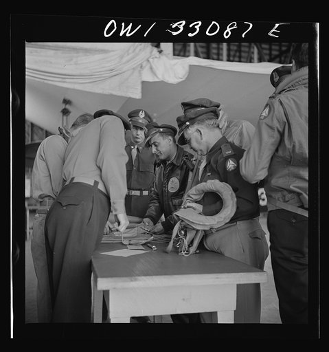 Untitled photo, possibly related to: Bar Harbor, Maine. Civil Air Patrol base headquarters of coastal patrol no. 20. Routine check of "Mae West" life preservers