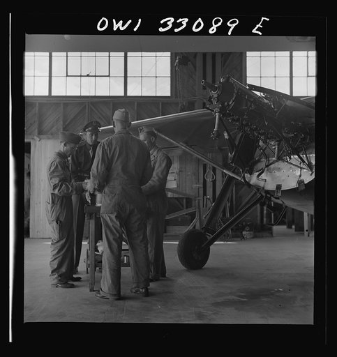 Untitled photo, possibly related to: Bar Harbor, Maine. Civil Air Patrol base headquarters of coastal patrol no. 20. Plane engine receiving a routine overhaul in the hangar