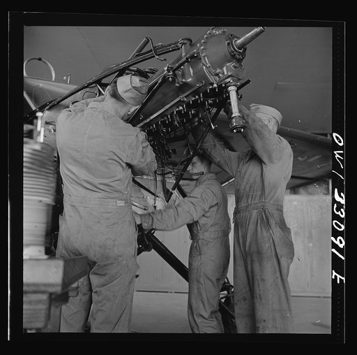 Untitled photo, possibly related to: Bar Harbor, Maine. Civil Air Patrol base headquarters of coastal patrol no. 20. Plane engine receiving a routine overhaul in the hangar