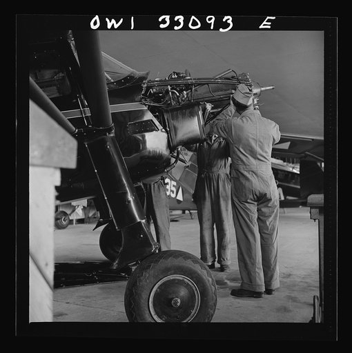 Untitled photo, possibly related to: Bar Harbor, Maine. Civil Air Patrol base headquarters of coastal patrol no. 20. Plane engine receiving a routine overhaul in the hangar