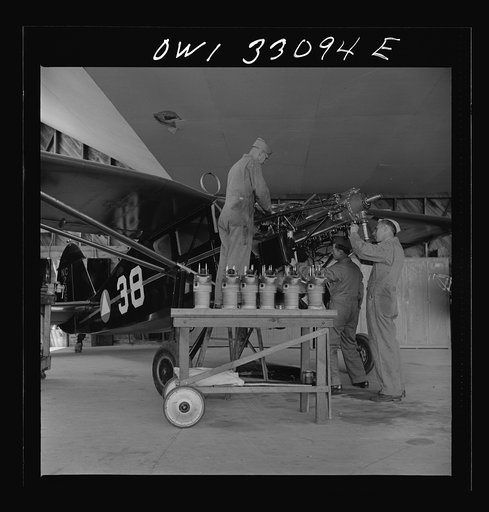 Bar Harbor, Maine. Civil Air Patrol base headquarters of coastal patrol no. 20. Replacing the cylinders in a plane after overhauling it
