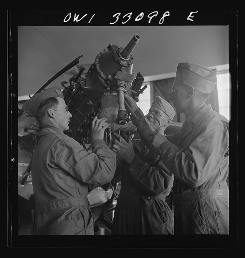 Untitled photo, possibly related to: Bar Harbor, Maine. Civil Air Patrol base headquarters of coastal patrol no. 20. Replacing the cylinders in a plane after overhauling it