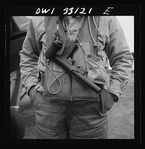 Bar Harbor, Maine. Civil Air Patrol base headquarters of coastal patrol no. 20. A flyer's safety equipment consists of a folding crash boat folded up in a zipper bag, "Mae West" life preservers, a Very pistol, a flashlight with red lens, and a container of dye to facilitate detection in the water