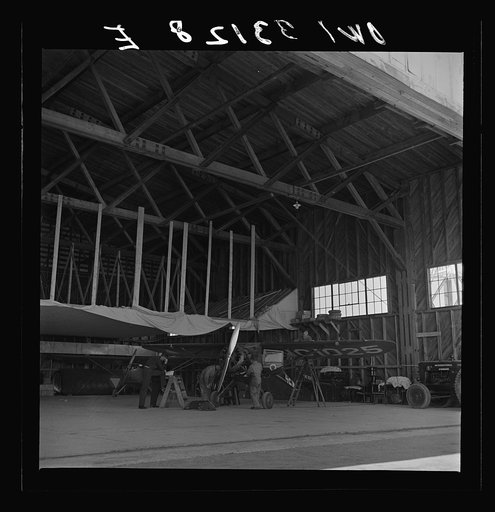 Bar Harbor, Maine. Civil Air Patrol base headquarters of coastal patrol no. 20. The false ceiling in the background of the hangar covered with canvas is for heating up the planes in winter
