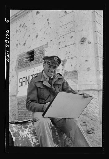 Tripoli, Libya. Lieutenant William Marx of New York City, attached to the public relations office of the U.S. Army 9th Air Force, doing some painting in the streets