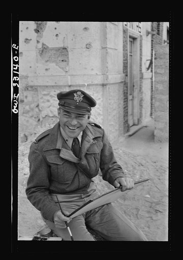 Untitled photo, possibly related to: Tripoli, Libya. Lieutenant Milton Marx of New York City, attached to the public relations office of the U.S. Army 9th Air Force, doing some painting in the street. In civilian life, Marx is a commercial artist