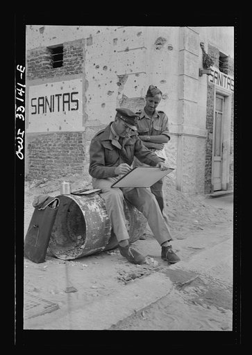 Tripoli, Libya. Lieutenant Milton Marx of New York City, attached to the public relations office of the U.S. Army 9th Air Force, doing some painting in the streets. In civilian life, Marx is a commercial artist
