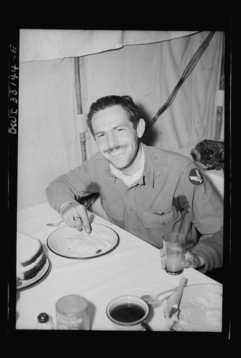 Lieutenant Richard E. Duffey, twenty-four, Walled Lake, Michigan, who accounted for five German Junker-52 transport planes over the Sicilian straits, eating on his return to 57th Fighter Group base somewhere in Tunisia
