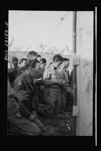 Untitled photo, possibly related to: Archbishop Francis J. Spellman of New York touring the North African battle front, saying mass for the men at the 57th Fighter Group of the U.S. Army 9th Air Force. This group, located "somewhere in Tunisia," knocked almost 100 Axis transports and fighters out of