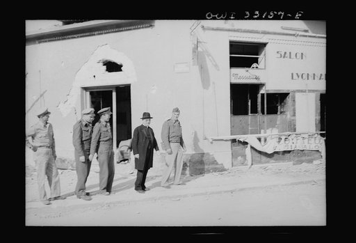 Sousse, Tunisia. Archbiship Spellman of New York and flyers of the US Army 9th airforce, touring the street to inspect bomb damage